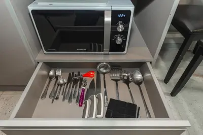 a drawer in a cabinet with utensils in it at C207 Rooftop Pool & King Bed, Walk to Surin Beach in Surin Beach