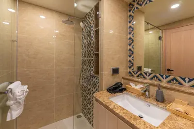 a bathroom with a sink and a shower at The Ozone Residences Bangtao in Phuket