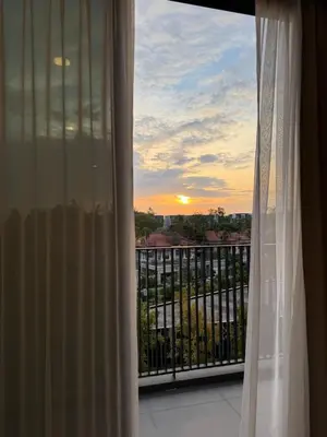 a view of a sunset from a window at 2BR Rooftop Pool & Gym Laguna Skypark in Laguna Phuket