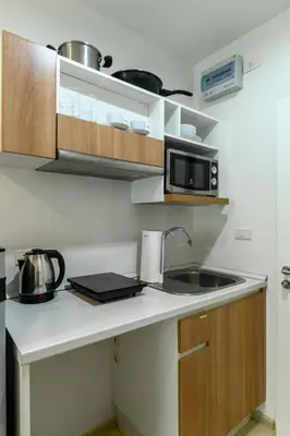 a kitchen with a sink and a microwave at Zcape 2 Phuket by RESAVA in Bang Tao Beach