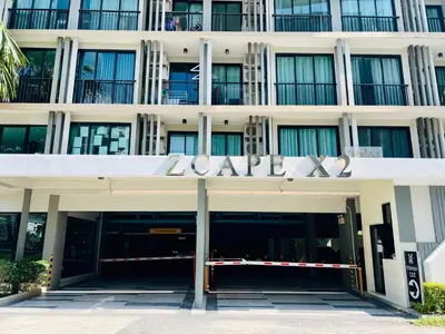 a large white building with a large sign on it at Zcape 2 Phuket by RESAVA in Bang Tao Beach