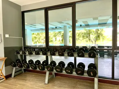 a bunch of wine bottles on a shelf in a room at Zcape 2 Phuket by RESAVA in Bang Tao Beach
