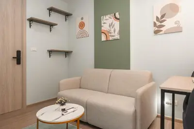 a living room with a couch and a table at C210 Peaceful Retreat in Heart of Phuket in Kathu