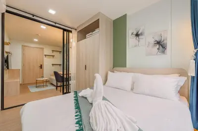 a bedroom with a large white bed in a room at C210 Peaceful Retreat in Heart of Phuket in Kathu