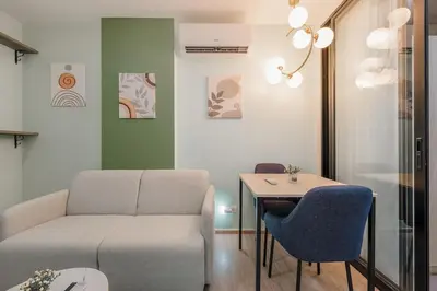 a living room with a couch and a table at C210 Peaceful Retreat in Heart of Phuket in Kathu