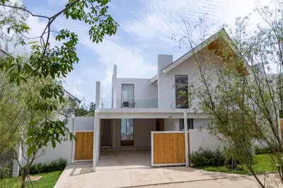 a white house with yellow doors and trees at New Tropical Modernity! 3BR Pool Villa LuxPride4 L21 near Laguna Phuket in Bang Tao Beach