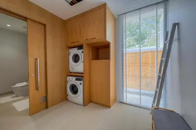 a laundry room with a washing machine next to a window at New Tropical Modernity! 3BR Pool Villa LuxPride4 L21 near Laguna Phuket in Bang Tao Beach