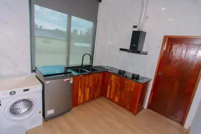a kitchen with a sink and a washing machine at Seashine Private Pool Villa at Klong Muang in Klong Muang Beach