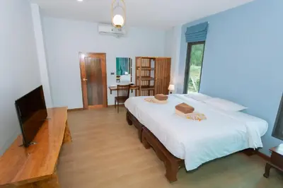 a bedroom with a large bed and a television at Seashine Private Pool Villa at Klong Muang in Klong Muang Beach
