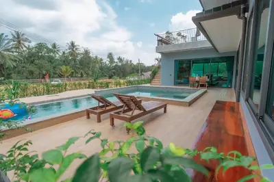 a house with a swimming pool and a house at Seashine Private Pool Villa at Klong Muang in Klong Muang Beach