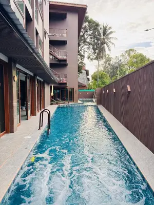 a swimming pool in front of a building at The Legacy V Beachfront Resort Ao Nang Krabi, Aspira Collection - Adults only in Ao Nang Beach