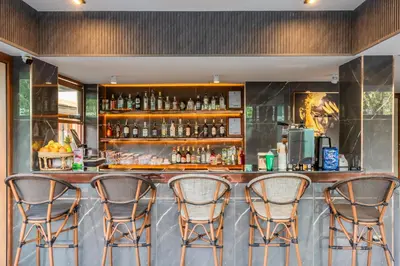 a bar with four chairs in front of it at The Legacy V Beachfront Resort Ao Nang Krabi, Aspira Collection - Adults only in Ao Nang Beach