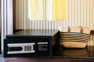 a black microwave with a basket next to it at The Legacy V Beachfront Resort Ao Nang Krabi, Aspira Collection - Adults only in Ao Nang Beach