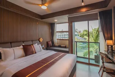 a bedroom with a large bed and a large window at The Legacy V Beachfront Resort Ao Nang Krabi, Aspira Collection - Adults only in Ao Nang Beach