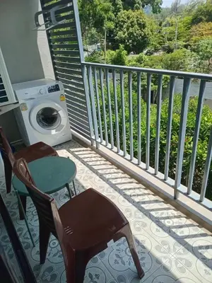 a balcony with a washing machine and a table and chairs at В11 Title Naiyang Ватсап669З5В2I976 in Nai Yang Beach