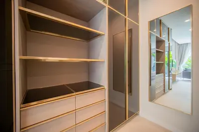 a walk in closet with wooden shelves and a mirror at 3BR Villa Z by NLA in Bang Tao Beach