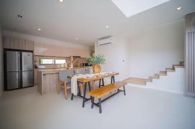 a kitchen and dining room with a table and chairs at 3BR Villa Z by NLA in Bang Tao Beach