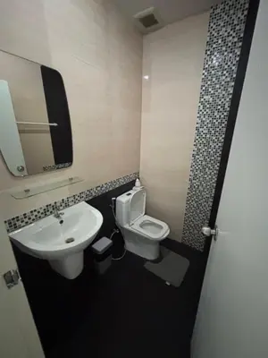 a bathroom with a sink and a toilet and a mirror at Laguna Townhouse with private pool and your own gym near Bangtao Beach in Laguna Phuket