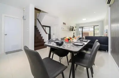 a dining room with a table and chairs at Laguna Townhouse with private pool and your own gym near Bangtao Beach in Laguna Phuket