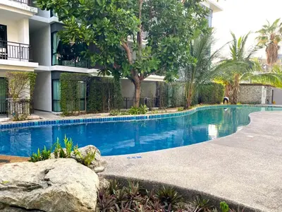a swimming pool in front of a building at Apartment Title I, Rawai Phuket in Rawai Beach