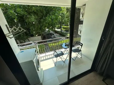 a view of a balcony with a table and chairs at Apartment Title I, Rawai Phuket in Rawai Beach