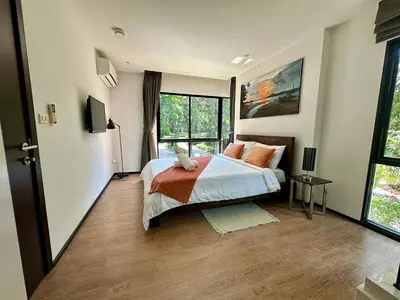 a bedroom with a bed and a large window at Apartment Title I, Rawai Phuket in Rawai Beach