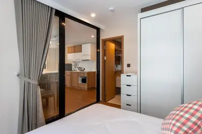 a bedroom with a large glass door leading to a kitchen at Cozy apartment in Title V 400 m to Rawai Beach in Rawai Beach