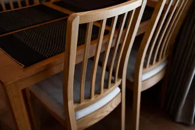 a pair of wooden chairs sitting at a table at Cozy apartment in Title V 400 m to Rawai Beach in Rawai Beach