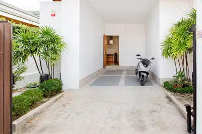 a motorcycle parked in front of a building at Serene Contemporary Villa with a Swimming Pool in Ban Saiyuan (1)