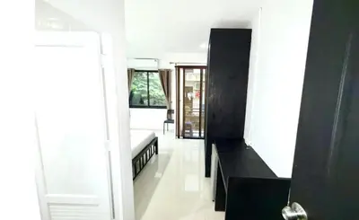a living room with a bed and a black cabinet at Patong Easy Life 3 in Patong Beach