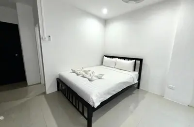 a bedroom with a bed with shoes on it at Patong Easy Life 3 in Patong Beach