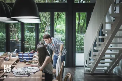 a man and a woman standing in front of a table at Blu Monkey Hub and Hotel Phuket Town- Free All Day Coworking space in Phuket Town