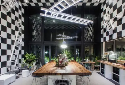 a room with a wooden table and chairs in it at Blu Monkey Hub and Hotel Phuket Town- Free All Day Coworking space in Phuket Town