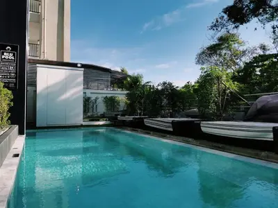 a swimming pool in the middle of a house at Blu Monkey Hub and Hotel Phuket Town- Free All Day Coworking space in Phuket Town