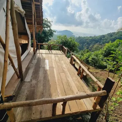a wooden boardwalk leading to a house with a view at Sea True Valley Phuket ซี ทรู วัลเลย์ ภูเก็ต in Ban Ao Makham