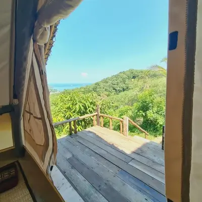 a view from the inside of a rv with a wooden deck at Sea True Valley Phuket ซี ทรู วัลเลย์ ภูเก็ต in Ban Ao Makham