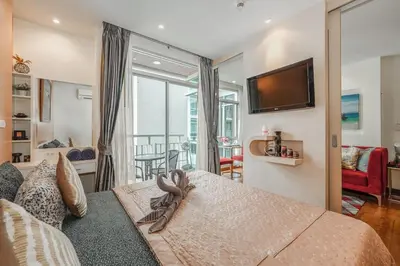 a bedroom with a large bed and a television at C211 Motorbike Friendly 950m to Patong Beach Pool&Gym in Patong Beach