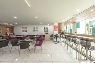 a restaurant with tables and chairs and a bar at C211 Motorbike Friendly 950m to Patong Beach Pool&Gym in Patong Beach