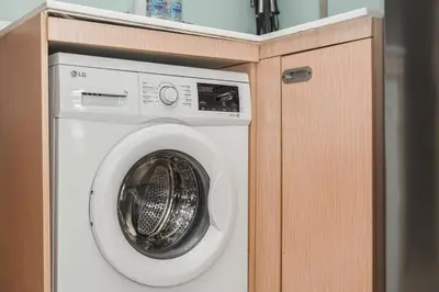 a washing machine in a wooden cabinet at C211 Motorbike Friendly 950m to Patong Beach Pool&Gym in Patong Beach