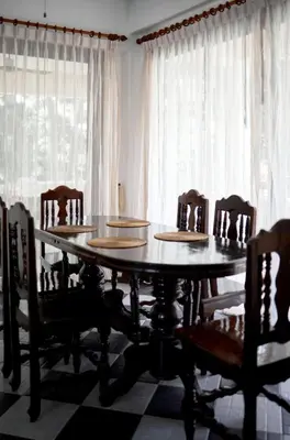 a dining room with a wooden table and chairs at Вилла с 6 спальнями в районе Раваи in Ban Suan