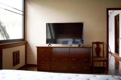 a bedroom with a dresser with a flat screen tv on it at Вилла с 6 спальнями в районе Раваи in Ban Suan