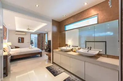 a bathroom with two sinks and a bed at V210 Retreat 3BR Top of the Range, Sea View,Lift in Rawai Beach