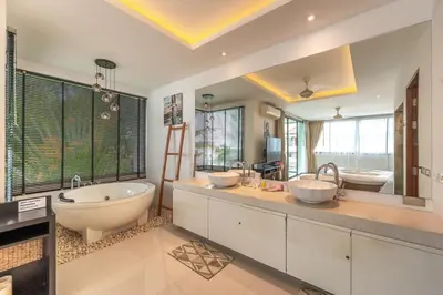 a bathroom with two sinks and a tub and a tubermott at V210 Retreat 3BR Top of the Range, Sea View,Lift in Rawai Beach