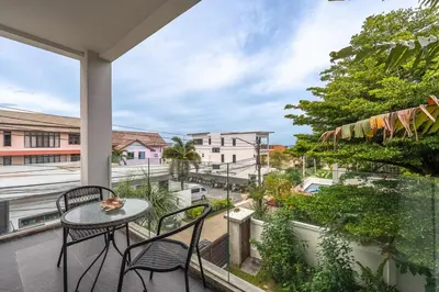 a balcony with a table and chairs and a view at V210 Retreat 3BR Top of the Range, Sea View,Lift in Rawai Beach