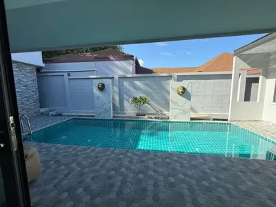 a swimming pool in front of a house at Quiet Harbor in Ban Saiyuan (1)