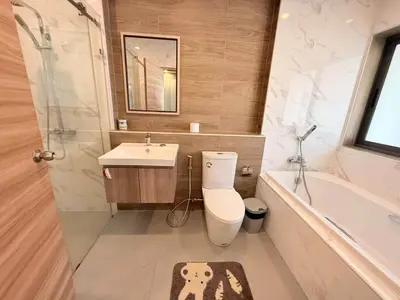 a bathroom with a toilet and a sink and a tub at Quiet Harbor in Ban Saiyuan (1)