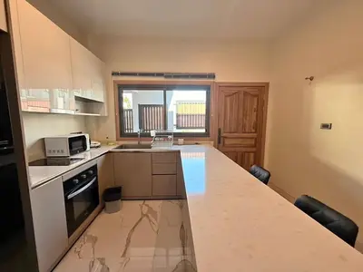 a small kitchen with a counter top and a counter top at Quiet Harbor in Ban Saiyuan (1)