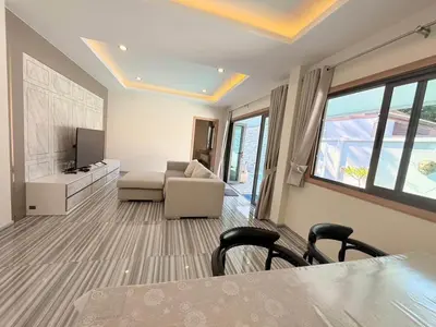 a living room with a couch and a tv at Quiet Harbor in Ban Saiyuan (1)