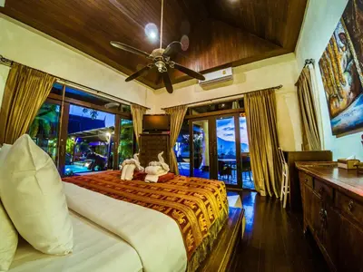 a bedroom with a bed with two teddy bears on it at Luxury 8 - 9 Bedroom Villa With 2 Pools in Kamala Beach