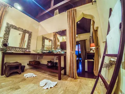 a room with a bed with a mirror and a ladder at Luxury 8 - 9 Bedroom Villa With 2 Pools in Kamala Beach